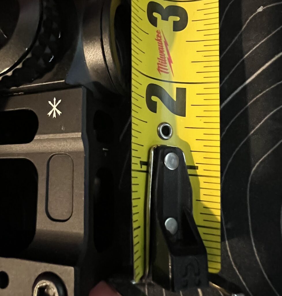 Confirmed about 2 and a quarter inches from top of rail to center of optic.